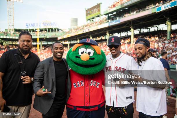 Kendrick Bourne of the New England Patriots poses for a photograph with mascot Wally the Green Monster before throwing out a ceremonial first pitch...