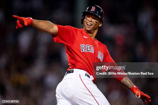 Rafael Devers of the Boston Red Sox reacts after hitting a go-ahead two run home run during the third inning of a game against the New York Yankees...