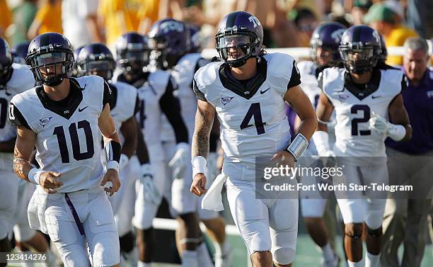 Texas Christian University quarterback Casey Pachall leads the Horned Frogs onto the field at Floyd Casey Stadium in Waco, Texas, as TCU plays...