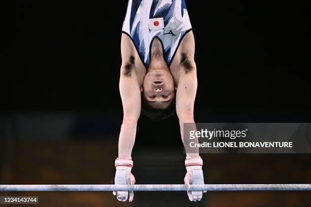 Japan's Kohei Uchimura competes in the horizontal bars event of the artistic gymnastics men's qualification during the Tokyo 2020 Olympic Games at...