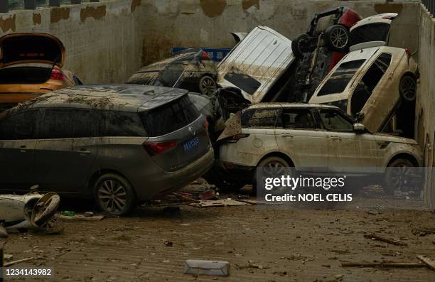 Damaged vehicles stacked on each other are seen in a car park following heavy rain which caused flooding earlier in the week that claimed at least 56...