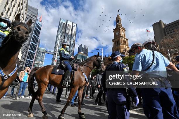 Police try to disperse protesters during an anti-lockdown rally in Sydney on July 24 as thousands of people gathered to demonstrate against the...