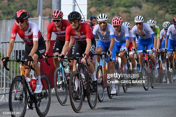 Cyclists ride in the peloton during the first lap of the Fuji International Speedway in the men's cycling road race of the Tokyo 2020 Olympic Games...
