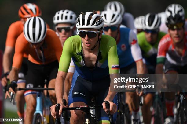 Slovenia's Tadej Pogacar rides on the peloton during the first lap of the Fuji International Speedway in the men's cycling road race of the Tokyo...