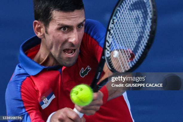 Serbia's Novak Djokovic returns a shot to Bolivia's Hugo Dellien during their Tokyo 2020 Olympic Games men's singles first round tennis match at the...