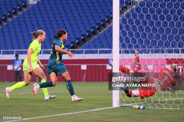 Australia's forward Sam Kerr scores a goal past Australia's goalkeeper Lydia Williams during the Tokyo 2020 Olympic Games women's group G first round...