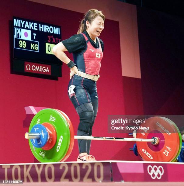 Japanese weightlifter Hiromi Miyake is pictured after failing to lift 99 kilograms in the jerk portion of the women's 49-kilogram event at the Tokyo...