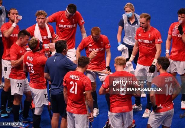 Britain's coach Zak Jones speaks to players during the men's pool B match of the Tokyo 2020 Olympic Games field hockey competition against South...