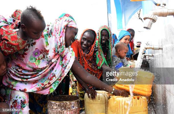Chadian people gather around clean water in N'Djamena, Chad on July 23, 2021. With the donations of Turkish benefactors and under the leadership of...