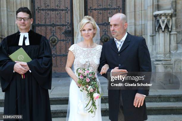 Bride Andrea Kathrin Loewig and her husband Andreas Thiele after their wedding ceremony on July 24, 2021 at Thomaskirche in Leipzig, Germany.