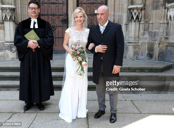 Bride Andrea Kathrin Loewig and her husband Andreas Thiele after their wedding ceremony on July 24, 2021 at Thomaskirche in Leipzig, Germany.