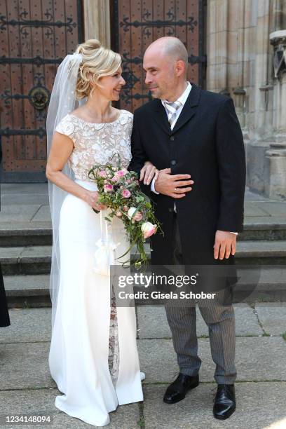 Bride Andrea Kathrin Loewig and her husband Andreas Thiele after their wedding ceremony on July 24, 2021 at Thomaskirche in Leipzig, Germany.