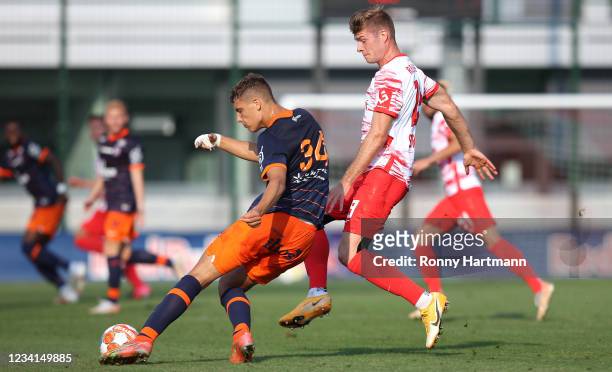 Alexander Sorloth of RB Leipzig and Maxime Esteve of Montpelier during the pre-season friendly match between RB Leipzig and HSC Montpellier at RB...