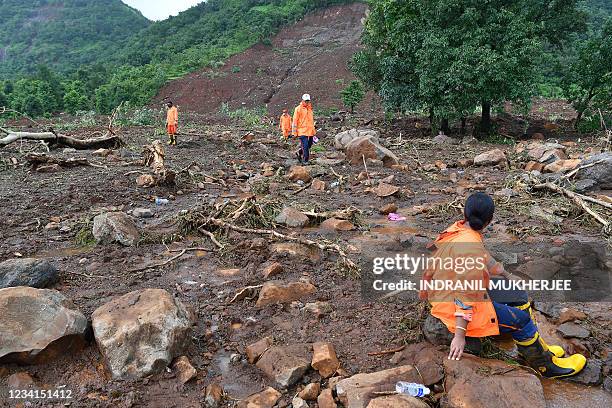 National Disaster Response Force personnel search for victims after a landslide at Taliye, about 22 km from Mahad city on July 24 as the death toll...