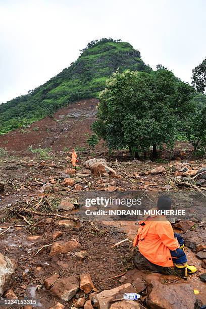 National Disaster Response Force personnel rests as others search for victims after a landslide at Taliye, about 22 km from Mahad city on July 24 as...