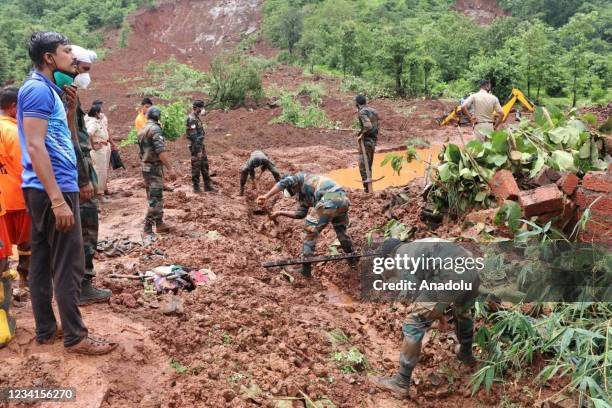 Indian Army personnel search for victims at the site of a landslide at area in Kolhapur, Saturday, July 24, 2021. The death toll from rain-related...
