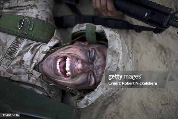 Marine Corps recruits pull a "wounded" Marine across wet sand while under simulated attack during the 54-hour Crucible exercise January 6, 2011 at...