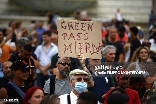 Protester holds a placard reads 'Shit Green Pass' as he takes part in a demonstration in Piazza del Popolo in Rome on July 24 against the...
