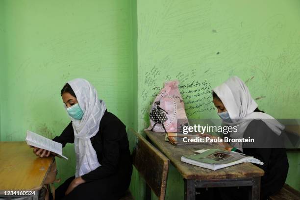 Afghan female students study during class at the Zarghoona high school on July 24 2021 in Kabul, Afghanistan. The Zarghoona girls high school is one...