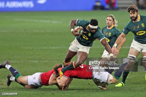 Siya Kolisi of Springboks being tackled by Owen Farrell and Hamish Watson of the B&I Lions during the Castle Lager Lions Series 1st Test match...