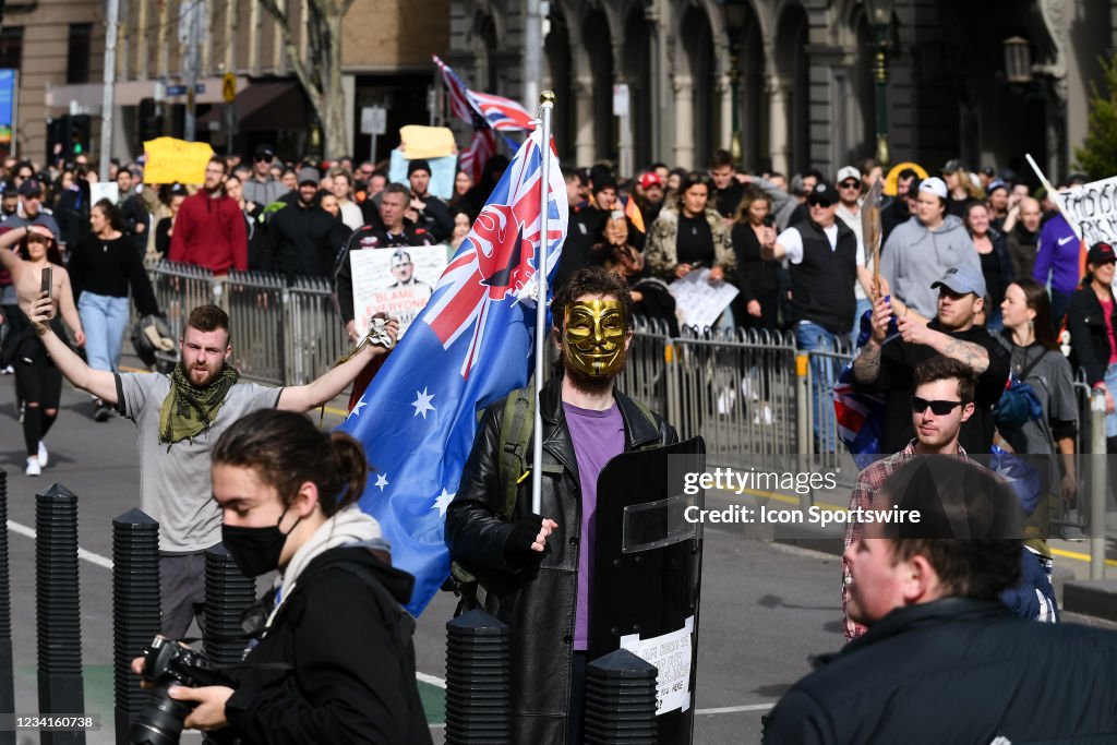 Freedom Rally Melbourne A protester in a Guy Fawkes mask marches up Spring Street during the ...