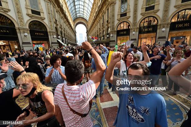 Protesters take part in a demonstration at Vittorio Emanuele II shopping mall in Milan on July 24 against the introduction of a mandatory 'green...