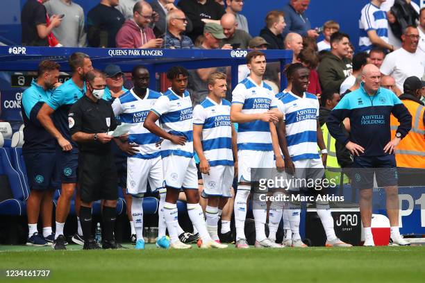 Mark Warburton manager of QPR looks on alongside his substitutes during the pre-season friendly between Queens Park Rangers and Manchester United at...