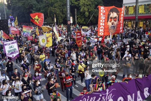 People take part in a demonstration against the Brazilian President Jair Bolsonaro's handling of the coronavirus pandemic in Sao Paulo, Brazil, on...