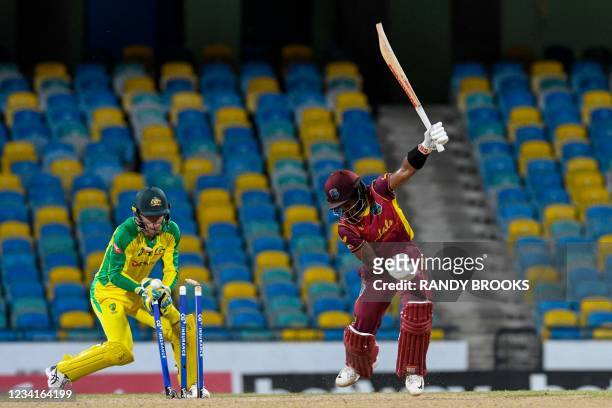 Shai Hope of West Indies is bowled and Alex Carey of Australia watch during the 2nd ODI between West Indies and Australia at Kensington Oval,...