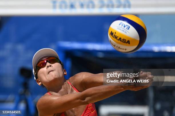 China's Xue Chen digs the ball in their women's preliminary beach volleyball pool B match between the USA and China during the Tokyo 2020 Olympic...