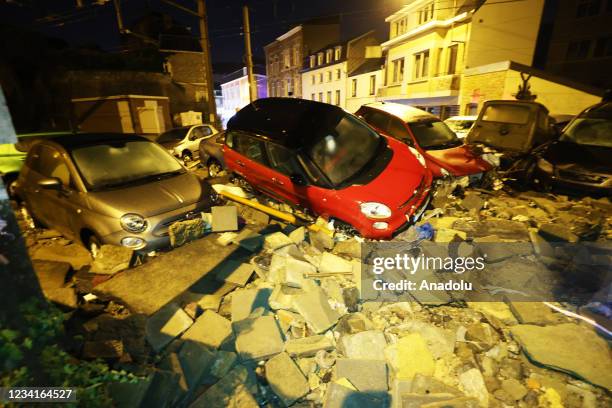 Damaged cars are piled up in Belgium's Dinant after heavy rain and floods caused major damage on July 24, 2021.