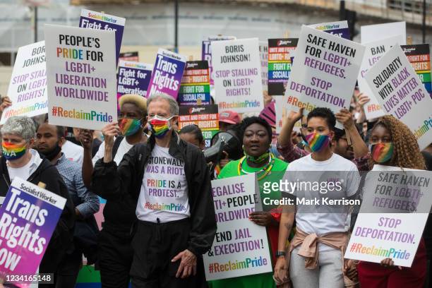 Peter Tatchell, veteran LGBTI+ and human rights campaigner, flanked by Linda Riley and Phyll Opoku-Gyimah, leads thousands of LGBTI+ protesters along...