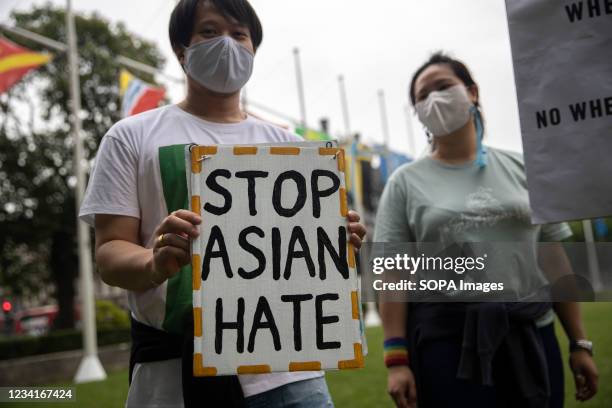 Protesters hold placards outside Parliament Square during the Stop Asian Hate rally in London. Demonstrators held a protest against the increasing...