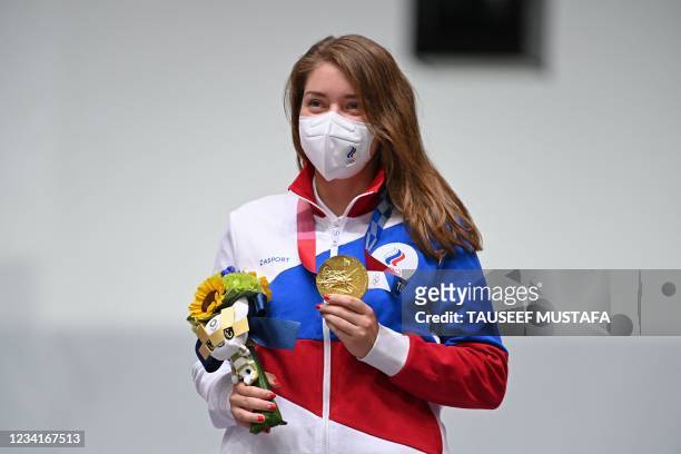 Gold medallist Russia's Vitalina Batsarashkina poses on the podium during the medal ceremony for the women's 10m air pistol final during the Tokyo...