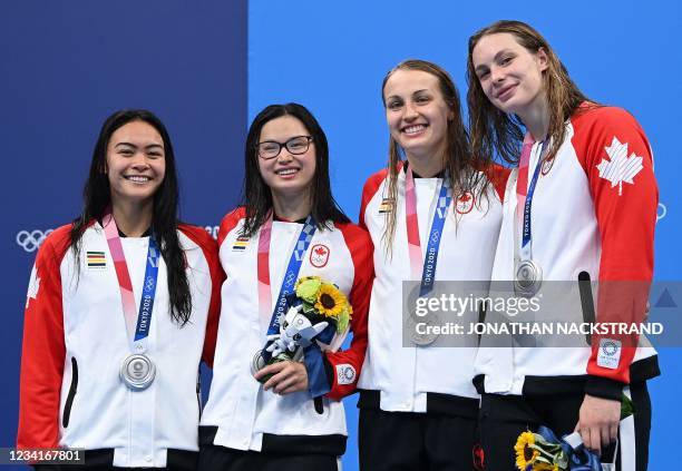 Silver medallists Canada's Penny Oleksiak, Canada's Rebecca Smith, Canada's Margaret Macneil and Canada's Kayla Sanchez pose on the podium after the...