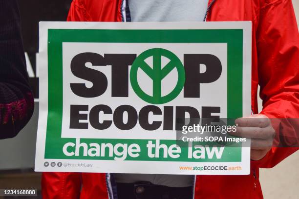 Protester holds a placard which says 'Stop Ecocide, Change The Law', during the demonstration. Forest Rebellion demonstrators, part of Extinction...