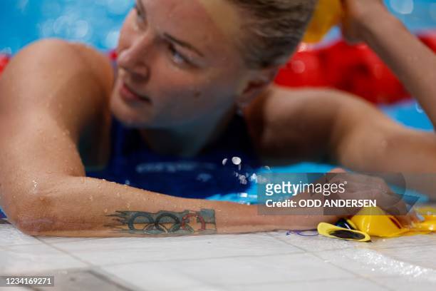 Sweden's Sarah Sjoestroem's tattoo is seen after she came in second in a semi-final of the women's 100m butterfly swimming event during the Tokyo...