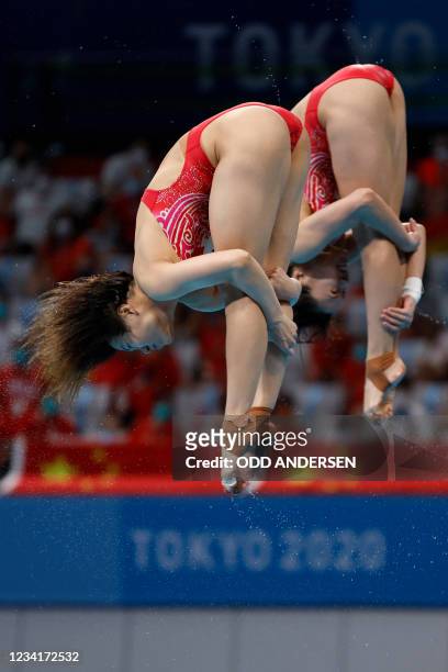 China's Shi Tingmao and China's Wang Han compete to win the gold medal in the women's synchronised 3m springboard diving final event during the Tokyo...