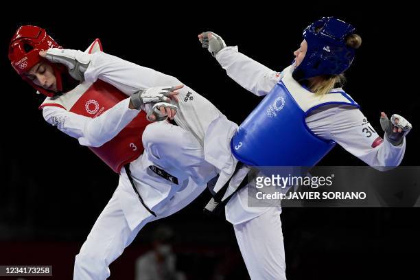 Russia's Tatiana Minina and Refugee Olympic Team's Kimia Alizadeh Zenoorin compete in the taekwondo women's -57kg semi-final bout during the Tokyo...