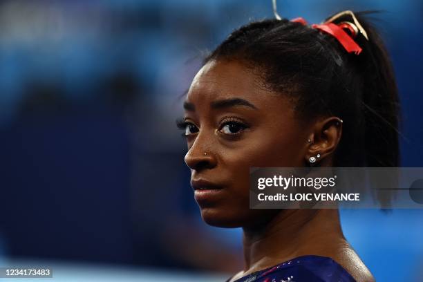 S Simone Biles gets ready to compete in the uneven bars event of the artistic gymnastics women's qualification during the Tokyo 2020 Olympic Games at...