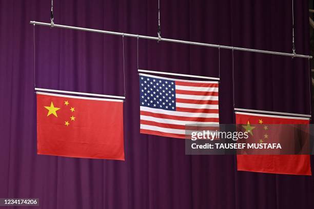 The US and Chinese flags are seen during the medal ceremony for silver medallist China's Sheng Lihao, gold medallist USA's William Shaner and bronze...