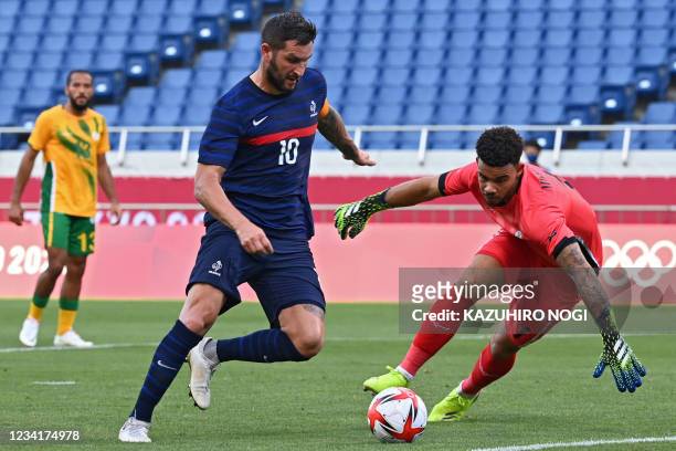 France's forward Andre-Pierre Gignac tries to score past South Africa's goalkeeper Ronwen Williams during the Tokyo 2020 Olympic Games men's group A...