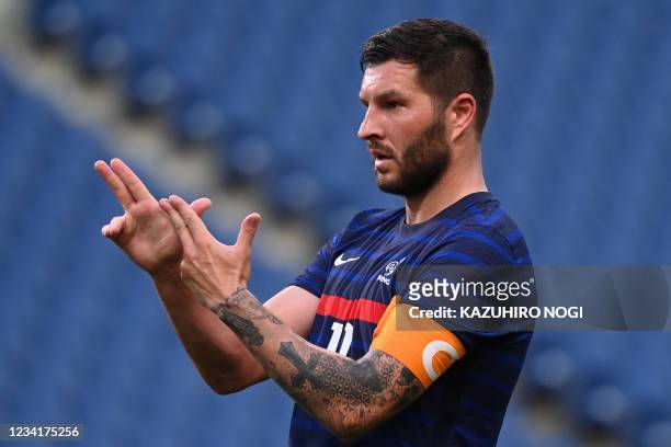 France's forward Andre-Pierre Gignac celebrates after scoring the equaliser during the Tokyo 2020 Olympic Games men's group A first round football...