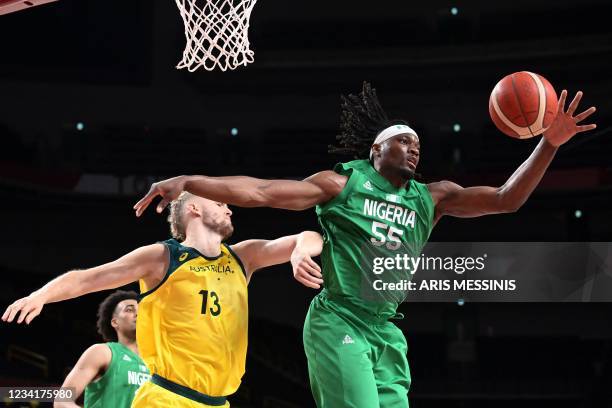 Nigeria's Precious Achiuwa handles the ball as Australia's Jock Landale watches in the men's preliminary round group B basketball match between...