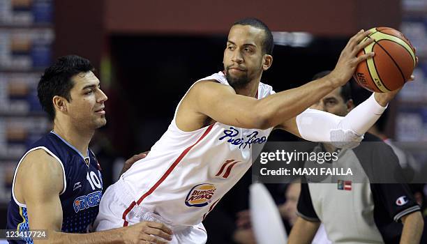 Ricardo Sanchez of Puerto Rico control the ball next to Carlos Delfino of Argentina during the qualifying round of the 2011 FIBA Americas...