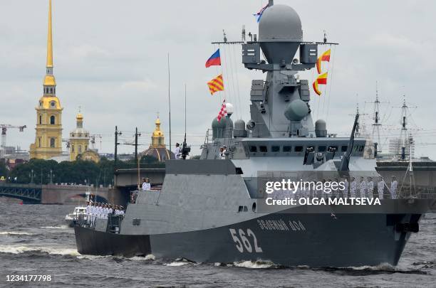 Soldiers stand at attention as Russian Navy warships take part in the Navy Day parade in St. Petersburg on July 25, 2021. / The erroneous mention[s]...