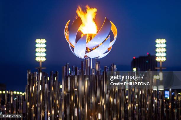 The Olympic flame is seen burning on the cauldron at Ariake Yume-no-Ohashi Bridge in Tokyo on July 25, 2021 during the Tokyo 2020 Olympic Games.