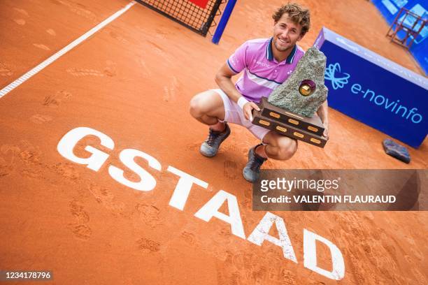 Norway's Casper Ruud raises the trophy after winning, against France's Hugo Gaston, the men's single final match at the Swiss Open ATP 250 tennis...