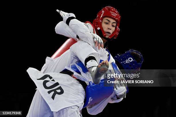 Turkey's Hatice Kubra Ilgun and Refugee Olympic Team's Kimia Alizadeh Zenoorin compete in the taekwondo women's -57kg bronze medal B bout during the...