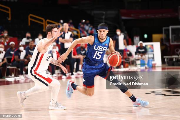 Devin Booker of the USA Men's National Team drives against Nando DE Colo of Team France at the Saitama Super Arena on July 25, 2021 in Tokyo, Japan....